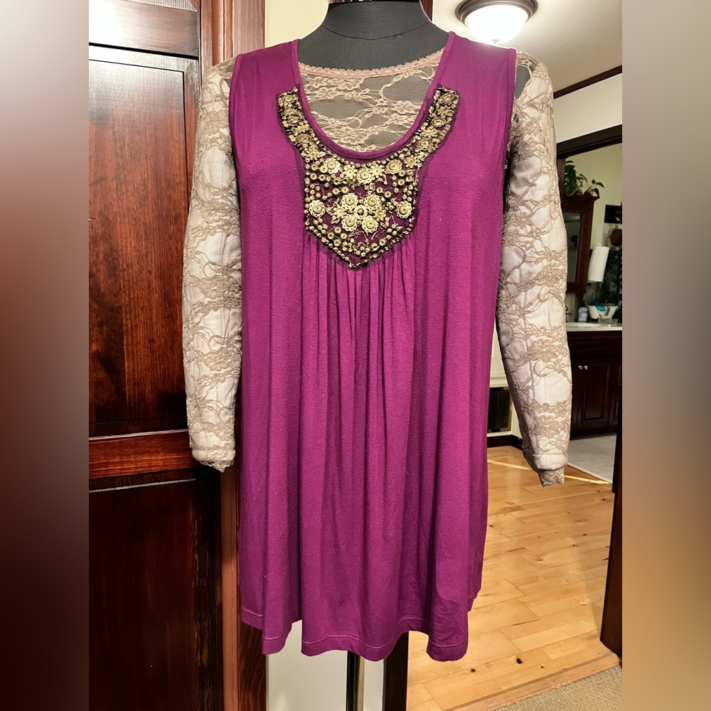 Green Dragon, 3x purple sleeveless tunic top with gold embellishment in front.